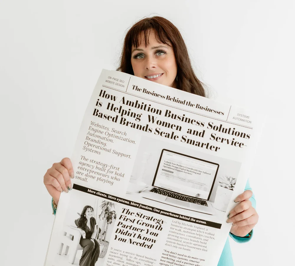 Michelle England Ceo  holds a large poster about Ambition Business Solutions for women and service-based brands.
