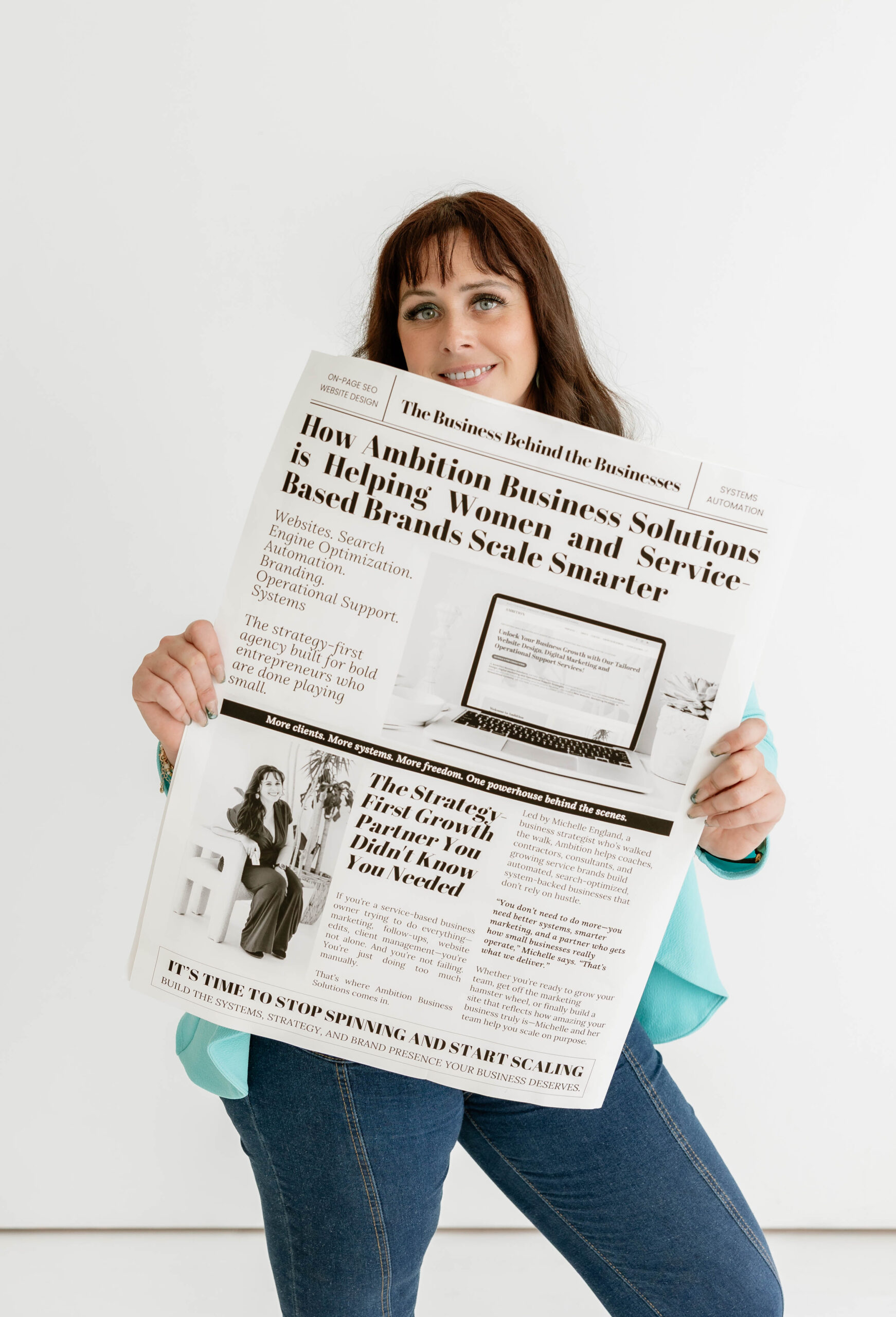 HB1A9656 Woman with brown hair smiling and holding a large newspaper featuring a business-related headline and images.