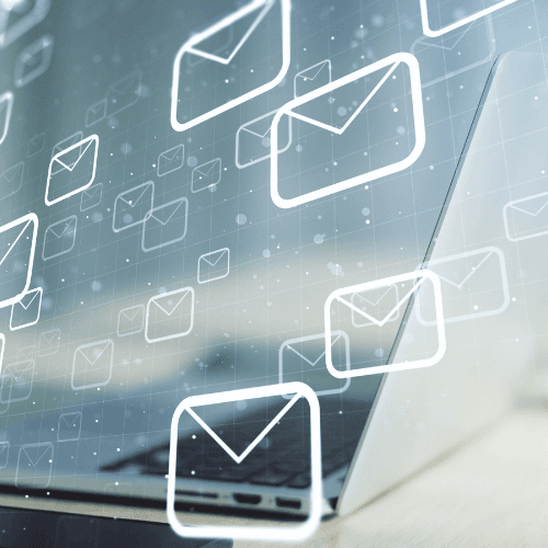 33 A laptop with digital envelope icons representing email notifications floating above the keyboard.