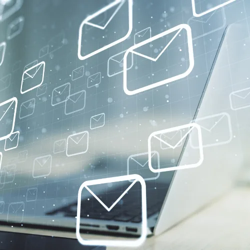 A laptop with digital envelope icons for email notifications, ideal for website or digital marketing use.