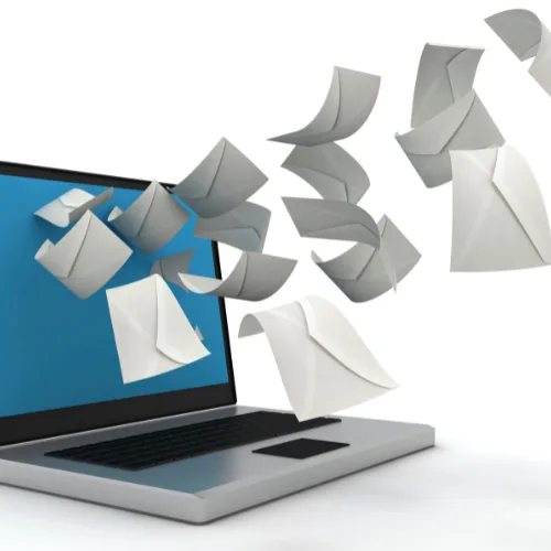 Envelopes flying out of a laptop screen, symbolizing marketing emails being sent or received.